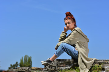 Fototapeta premium Beautiful redhead with blue eyes posing outdoor