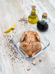 Chicken in marinade on a wooden table. 