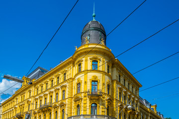 Yellow facade of a historical house situated on landstrasse street in the Austrian city Linz.