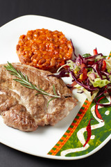 Pork steak with beans. Mexican food. Mexican cuisine.