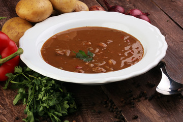 Tasty Hungarian beef goulash soup bograch close-up on the table and ingredient
