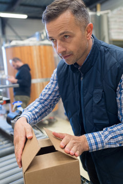 Man packaging product on the end of the production line