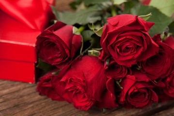 Bunch of red roses and gift box