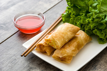 Vegetable spring rolls on wooden table background
