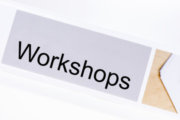 Office folder with the label workshops on white background