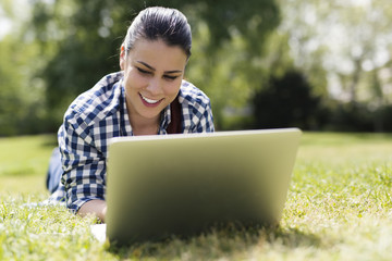 Smiling young woman using laptop