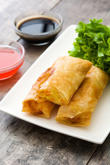 Vegetable spring rolls on wooden table background
