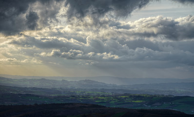 Cloudy landscape over the  farms and meadows
