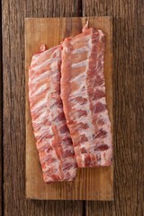 Beef ribs on wooden board