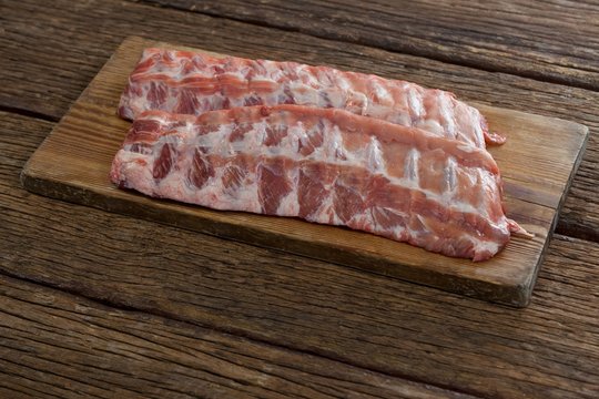 Beef ribs on wooden board