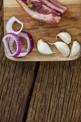 Blade chop, onions and garlic on wooden board