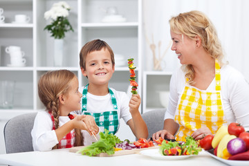 Happy young kids preparing a healthy snack