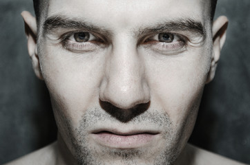 Obraz premium Portrait of a European male close-up with bristles on a gray background