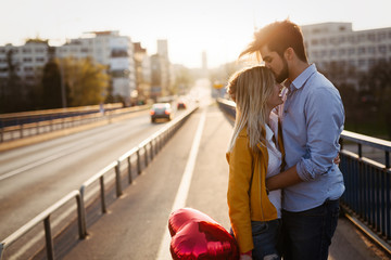 Romantic young couple in love, hugging on the street