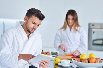 Happy couple cooking breakfast together in the kitchen