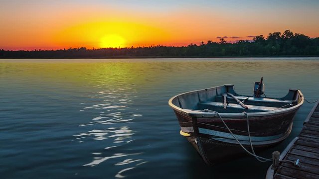 fishing boat on tranquil lake at sunset in Minnesota
