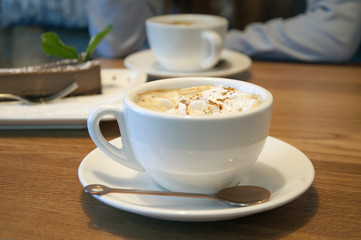 White cup of coffee in a Viennese close-up at a cafe.
