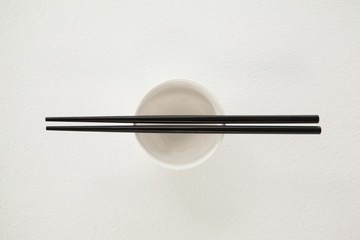 Pair of chopsticks over a bowl