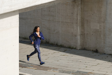 Fototapeta na wymiar Female urban athlete running outdoor.