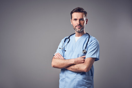 Doctor In Blue Uniform Standing With Crossed Arms, Isolated