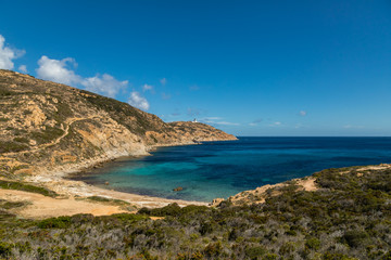 Fototapeta na wymiar Lighthouse and beach at Revellata in Corsica