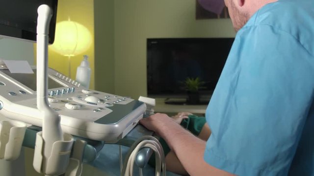 Doctor doing 3d ultrasound on belly of t woman in clinic 4k