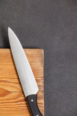 Knife on wooden board