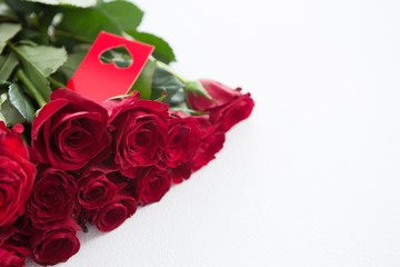 Bunch of red roses with tag