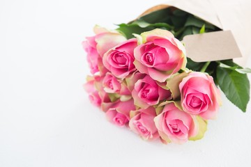 Bunch of pink roses with tag