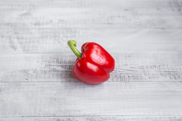 Fresh pepper on the table. Ecological wooden background.