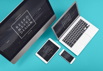 Two Computers, a Tablet, and a Smartphone on a Blue Background Mockup