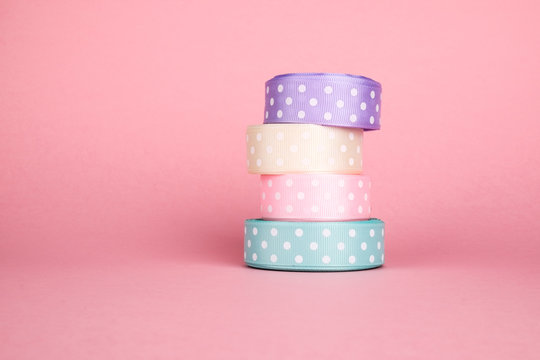 Closeup of ribbon roll over colorful background