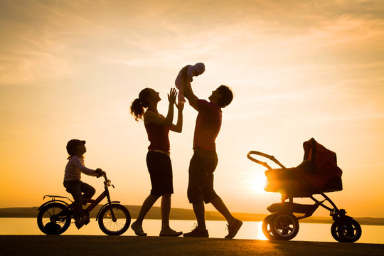 Happy family  at sunset