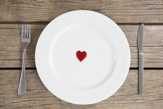 White plate with red heart in center