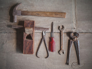 Top view of vintage tools on wooden floor