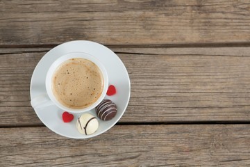Cup of coffee with chocolate and confectionery