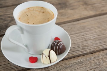 Cup of coffee with chocolate and confectionery
