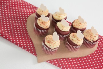 Cup cakes on heart shape paper