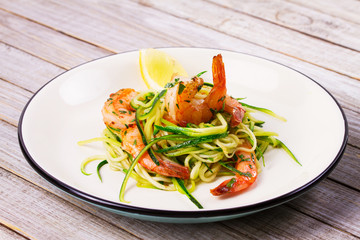 Shrimp with zucchini noodles. Prawns with vegetables and lemon