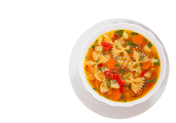 Fresh vegetable soup with farfalle pasta. top view. isolated on white