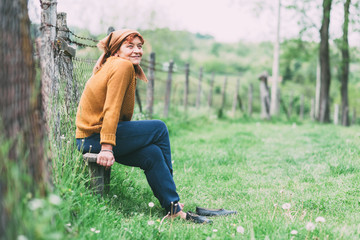 Peasant mature woman sitting on the bench resting