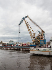 Fototapeta na wymiar Cargo crane in the port city of St. Petersburg
