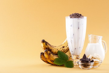 Milkshake with banana on yellow background