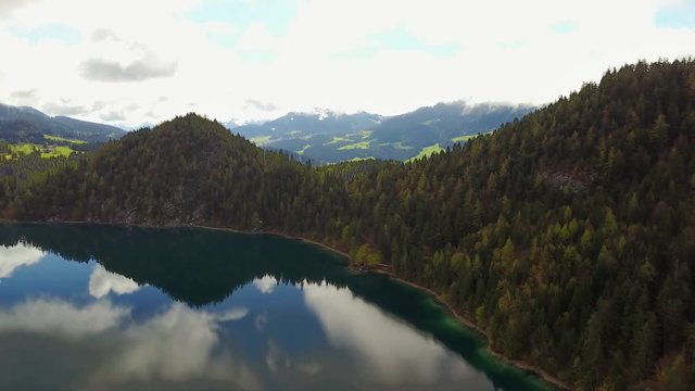 Aerial: flying over Hintersteiner Mountain lake with clear water in Austria 