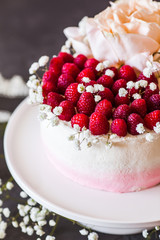 Sweet white cream mousse cake with raspberries on light background. (no baked cheesecake). Wedding cake
