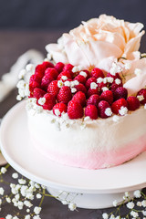 Sweet white cream mousse cake with raspberries on light background. (no baked cheesecake). Wedding cake