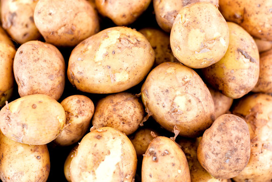 A stack of potatoes for sale in market
