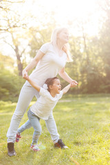 Fototapeta premium sporty mother and daughter. woman and child training in the park. outdoor sports. healthy sport lifestyle. fitness, yoga