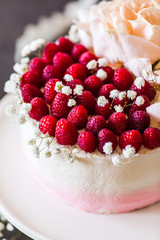 Sweet white cream mousse cake with raspberries on light background. (no baked cheesecake). Wedding cake