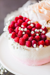 Sweet white cream mousse cake with raspberries on light background. (no baked cheesecake). Wedding cake